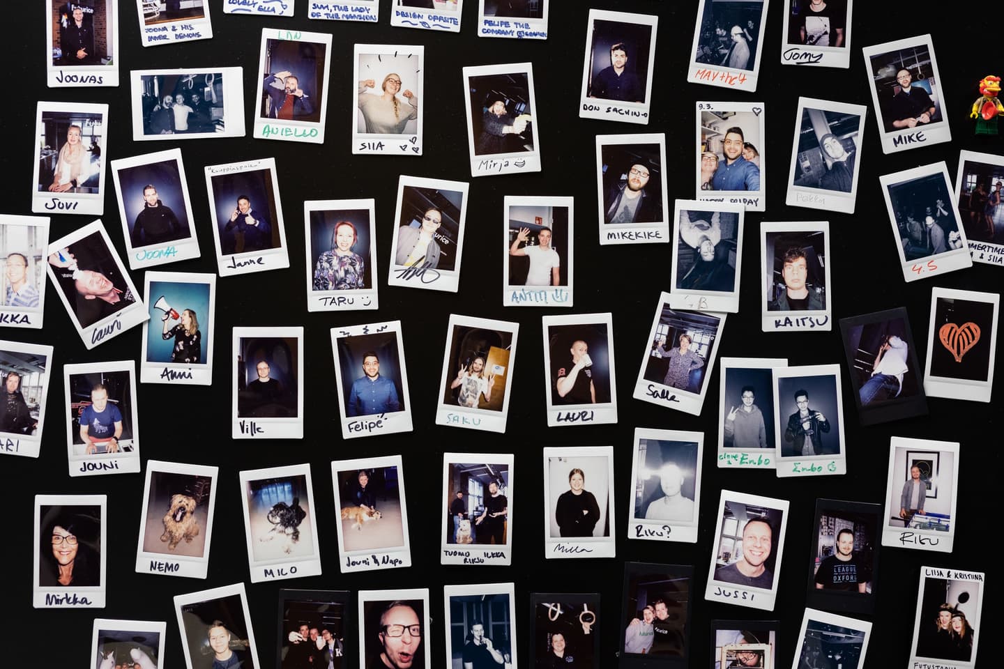 Collection of polaroid photographs arranged on a black background, each labeled with names like Siia, Mike, Jonne and Felipe.